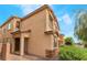 Exterior angle of a stuccoed two-story home with an inviting front entrance and brick-paved walkway at 3746 Asia Rd, North Las Vegas, NV 89032