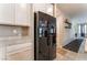 Modern refrigerator and white cabinets complement the sleek look of this contemporary kitchen at 3746 Asia Rd, North Las Vegas, NV 89032