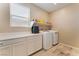 Functional laundry room with storage cabinets and modern washer/dryer at 3746 Asia Rd, North Las Vegas, NV 89032