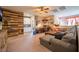 Cozy living room with a wood accent wall, built-in cabinets, and comfortable seating area with a ceiling fan at 3746 Asia Rd, North Las Vegas, NV 89032