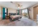 Relaxing main bedroom with a plush bed, ceiling fan, and sliding glass doors to the balcony with natural light at 3746 Asia Rd, North Las Vegas, NV 89032