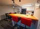 Modern kitchen featuring a breakfast bar with red stools, laminate floors and adjacent dining area at 3771 Desert Marina Dr # 95, Laughlin, NV 89029