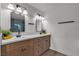 Double sink bathroom with modern fixtures and wood cabinets at 405 Oil Lantern Ln, Las Vegas, NV 89145