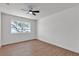 Bright bedroom with modern ceiling fan, new flooring and large window at 405 Oil Lantern Ln, Las Vegas, NV 89145