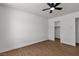 Well-lit bedroom features a modern ceiling fan and sleek wood-look floors at 405 Oil Lantern Ln, Las Vegas, NV 89145