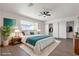 Bright bedroom featuring a large window, walk-in closets, and stylish decor at 405 Oil Lantern Ln, Las Vegas, NV 89145