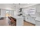 Stylish kitchen featuring white cabinets, an island with bar seating, and stainless steel appliances at 405 Oil Lantern Ln, Las Vegas, NV 89145