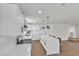 Bright kitchen with white cabinets, quartz countertops, an island with bar seating, and stainless appliances at 405 Oil Lantern Ln, Las Vegas, NV 89145