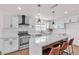 Modern kitchen featuring white cabinets, quartz counters, subway tile backsplash, and a breakfast bar at 405 Oil Lantern Ln, Las Vegas, NV 89145