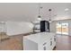Open layout featuring kitchen island with bar, fireplace, hardwood floors, and sliding door to the yard at 405 Oil Lantern Ln, Las Vegas, NV 89145
