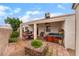 Covered patio with outdoor dining set, barbecue grill, and jacuzzi at 4110 Bonita Desert Ct, North Las Vegas, NV 89032