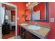 Bathroom featuring dual sinks, stylish mirrors and adjacent access to the bedroom at 4110 Bonita Desert Ct, North Las Vegas, NV 89032