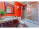 Bathroom has an accent wall and shower-bath with a glass door at 4110 Bonita Desert Ct, North Las Vegas, NV 89032