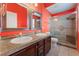 Bathroom with double sinks, granite countertops, and tile surround at 4110 Bonita Desert Ct, North Las Vegas, NV 89032