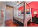 Spacious bedroom features a canopy bed, wood floors, and views of the hallway at 4110 Bonita Desert Ct, North Las Vegas, NV 89032