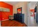 Spacious bedroom features wood floors, red accent wall, closet, and study space at 4110 Bonita Desert Ct, North Las Vegas, NV 89032