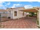 A view of the carport with tiled paving stones for a beautiful design, along with desert landscaping, and white exterior at 4110 Bonita Desert Ct, North Las Vegas, NV 89032