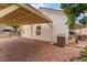 A view of the carport with tiled paving stones and wood covering, the perfect shady space with a nice view to the backyard at 4110 Bonita Desert Ct, North Las Vegas, NV 89032