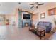 Comfortable living room features a stone fireplace, TV, and tile floors at 4110 Bonita Desert Ct, North Las Vegas, NV 89032