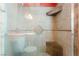 Shower with tiled walls, corner shelves, and a frameless glass door at 4110 Bonita Desert Ct, North Las Vegas, NV 89032