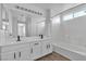 Bright bathroom features a double sink vanity, a large mirror and a shower tub combination at 4149 Dignified Ct, North Las Vegas, NV 89032