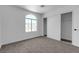 A sunlit bedroom features a carpeted floor, an arched window and a double door closet for ample storage at 4149 Dignified Ct, North Las Vegas, NV 89032