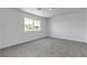 Spacious, carpeted bedroom with a large window providing natural light, and white trim at 4149 Dignified Ct, North Las Vegas, NV 89032