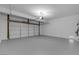 Spacious garage featuring bright lighting and a white garage door at 4149 Dignified Ct, North Las Vegas, NV 89032