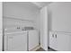 Bright laundry room featuring modern washer and dryer, with built-in shelving and storage cabinets at 4149 Dignified Ct, North Las Vegas, NV 89032