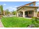 Expansive backyard with a manicured lawn, cozy patio seating, fire pit, and a sparkling pool at 419 Vigo Port St, Las Vegas, NV 89138