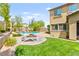 Lush backyard featuring a pool, fire pit, lounge chairs, and well-maintained lawn at 419 Vigo Port St, Las Vegas, NV 89138