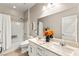 Clean bathroom featuring double vanity, shower over tub, and neutral decor at 419 Vigo Port St, Las Vegas, NV 89138