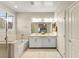 Bright bathroom with a double vanity, tub, and separate shower at 419 Vigo Port St, Las Vegas, NV 89138