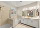 Bright bathroom with double vanity, bathtub, and glass enclosed shower at 419 Vigo Port St, Las Vegas, NV 89138