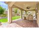 Charming covered patio with brick flooring, ceiling fan, and comfortable seating area at 419 Vigo Port St, Las Vegas, NV 89138