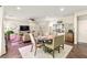 Open dining area featuring a table set for six, alongside a comfortable living space at 419 Vigo Port St, Las Vegas, NV 89138