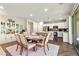 Elegant dining area with a round table, plush chairs, and a view into the modern kitchen at 419 Vigo Port St, Las Vegas, NV 89138