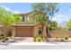 Charming two-story home with a well-manicured lawn, attached garage, and beautiful desert landscaping at 419 Vigo Port St, Las Vegas, NV 89138