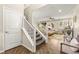 Welcoming foyer featuring a staircase, wood floors, and a glimpse into the naturally lit living space at 419 Vigo Port St, Las Vegas, NV 89138