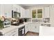 Bright kitchen featuring stainless appliances, light countertops, white cabinets and a decorative backsplash at 419 Vigo Port St, Las Vegas, NV 89138