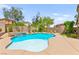 Refreshing backyard pool with a spa, mature landscaping, and a serene outdoor seating area at 419 Vigo Port St, Las Vegas, NV 89138