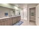Bathroom with double sinks, glass shower, and linen closet provides a spa-like experience at 4433 Bayley Skye Ave # 104, Las Vegas, NV 89141