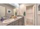 Well-lit bathroom with double sinks, granite counters, and a tub/shower combo at 4433 Bayley Skye Ave # 104, Las Vegas, NV 89141