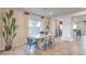 Bright dining room features a modern table, stylish chairs, and decorative plants at 4433 Bayley Skye Ave # 104, Las Vegas, NV 89141
