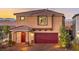 Two-story home boasts a red door, two-car garage, and manicured landscaping at 4433 Bayley Skye Ave # 104, Las Vegas, NV 89141