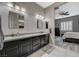 Bathroom with dual vanity, modern wave-texture wall, and an open view into the bedroom at 468 Harvest Rain, Las Vegas, NV 89011