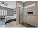 The ensuite bath features a glassed shower stall, black accents, and flows naturally into the bedroom at 468 Harvest Rain, Las Vegas, NV 89011