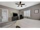 A bright bedroom features a ceiling fan, wood floors, neutral paint, and a door to the outside at 468 Harvest Rain, Las Vegas, NV 89011