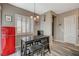Cozy breakfast nook features a wood table, cushioned stools, and a vintage-style red refrigerator at 468 Harvest Rain, Las Vegas, NV 89011