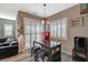 Bright breakfast nook with a wood table, stools, plantation shutters, and a vintage red refrigerator at 468 Harvest Rain, Las Vegas, NV 89011